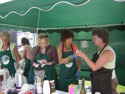 Ladies making and trying fruit drinks