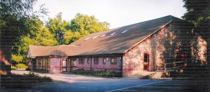 View of Chiddingfold Village Hall surounded by trees