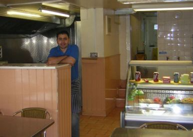Inside of cafe with counter  and worker