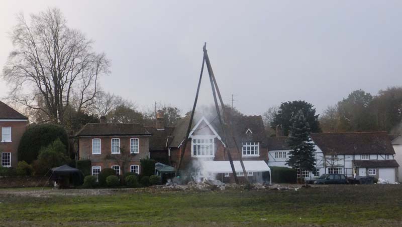 Remains of bonfire smoldering ashes and tripod which normaly burns