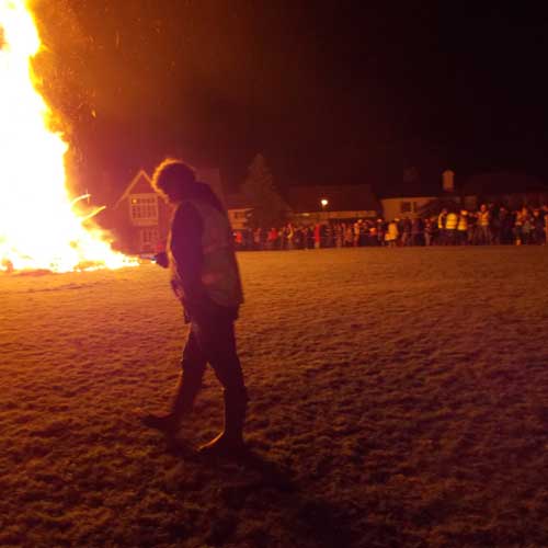 Marshall with walkie talkie bonfire in background