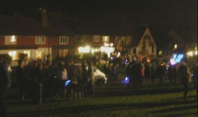 crowd in the dark at bottom of green