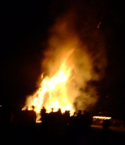 silouite of bonfire burning in dark