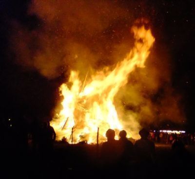 silouite of bonfire burning in dark