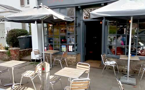 Tables and chairs outside coffee shop