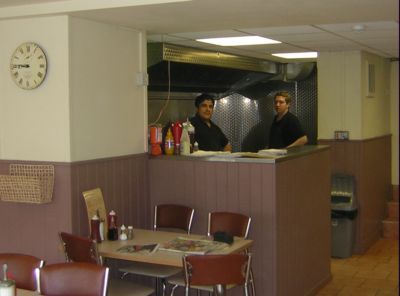Inside of cafe with counter  and worker
