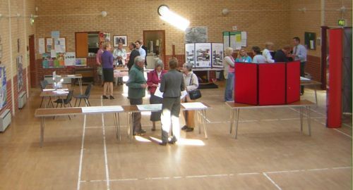 People in Village Hall loking and talking