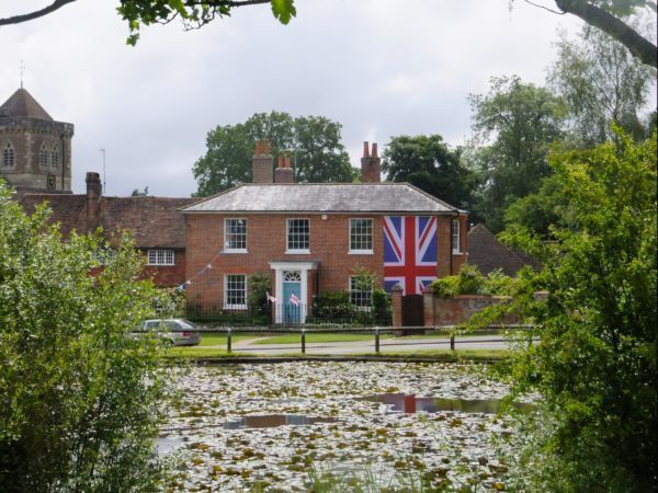 House by village pond with BIG Union Jack