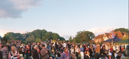 Crowd on green in front of stage