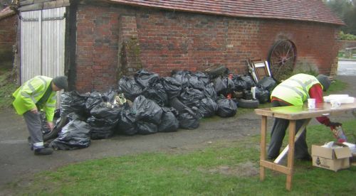 Black plastic rubish sacks against wall in Chiddingfold