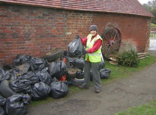Chiddingfold Parish Counciler Christine Tebbot with black plastic rubish sack