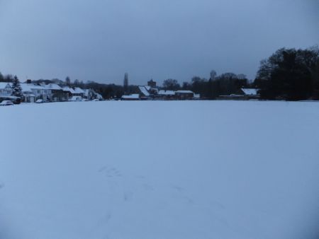 Snow scene Village Green with church in distance