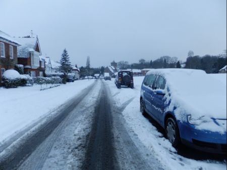 Snow scene road with parked cars