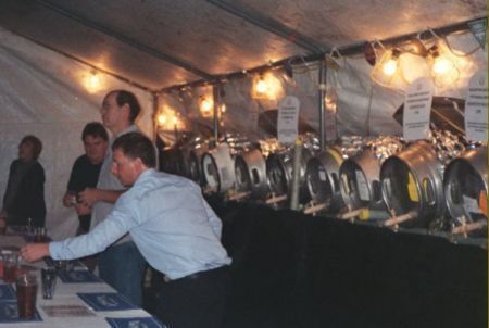 Outdoor bar with beer barrels and barstaff