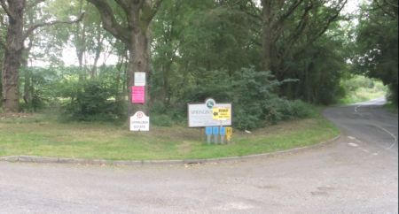 Signs on public road at entrance to festival