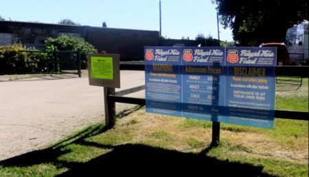 Notices displayed between campsite an festival field