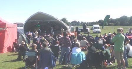 view of stage from back of field with crowd