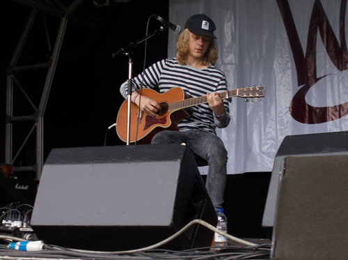 Man on stage with guitar