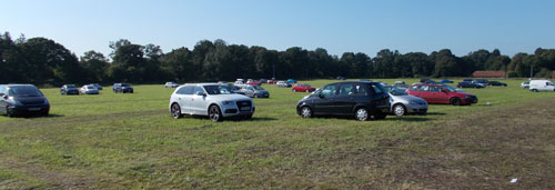 Cars parked in field most cars gone
