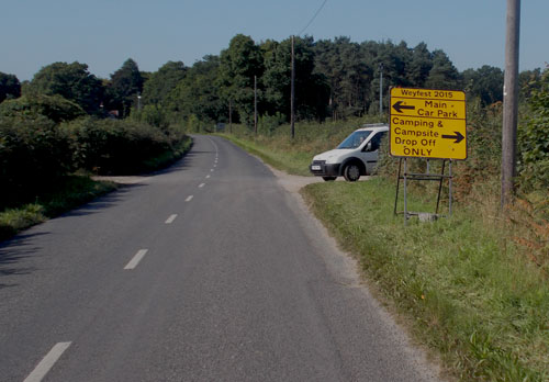 Yellow road signs and van leaving site