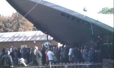 Smaller stage viewed from side with crowd
